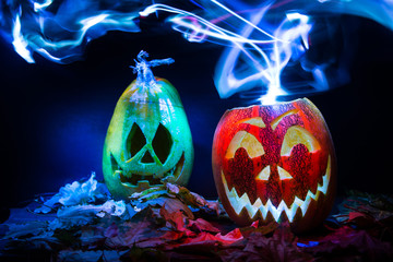 luminous pumpkins in the dark for the autumn Halloween holiday. Jack's grinning head. Magical bright neon red and blue light in the darkness of Freezelight. All Saints' Day