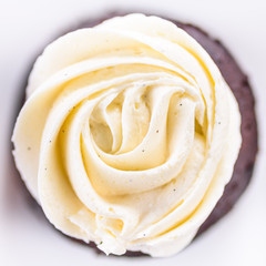 Chocolate cupcakes with various flavours of whipped cream