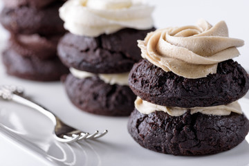 Chocolate cupcakes with various flavours of whipped cream
