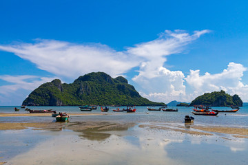 Fototapeta na wymiar Beach idyllic sky and fishing boat at Baan Koh Teap