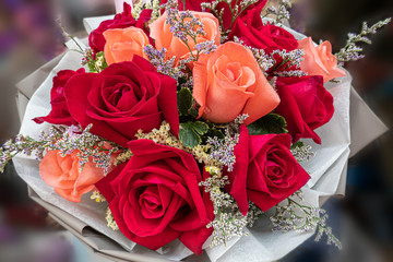 Colourful and beautiful bouquet of roses wrapped in paper , using depth of field effect
