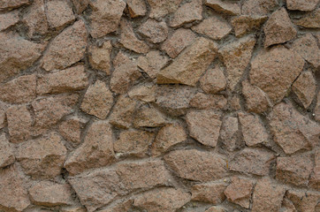 A stone wall of raw granite.