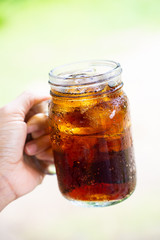 cola cola sparkling water in a glass with ice