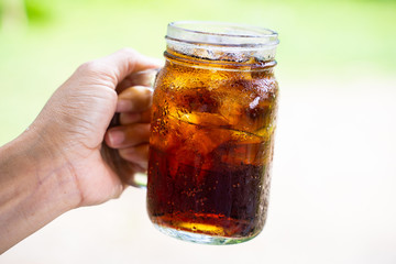 cola cola sparkling water in a glass with ice