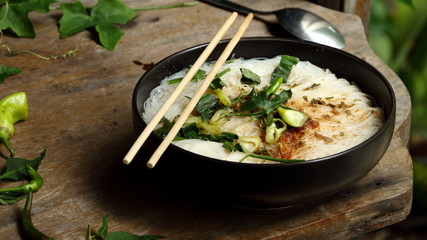 Instant Noodles in a Cup and vegetables on the wooden table background