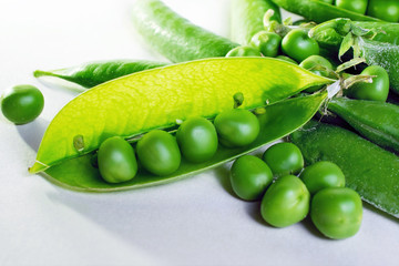 open green fresh pea pods on white background