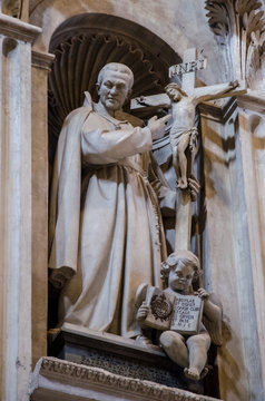 Statue of a priest holding a cross