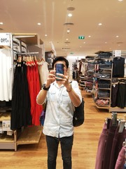 Take a picture of yourself in the mirror of a clothing store in the mall.in Thailand