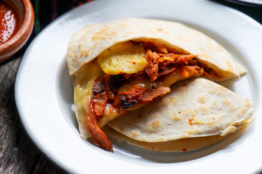 Mexican quesadilla with pork also called "gringa al pastor"
