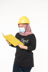 Asian woman wearing face masks due to the haze in situation while holding a book