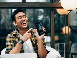 man working on tablet computer in cafe