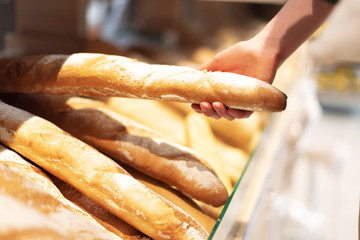 Girl choosing pastry in supermarket. Copy space. Healthy diet concept. Sustainable lifestyle.