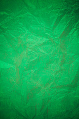 Crumpled green paper recycling background.
