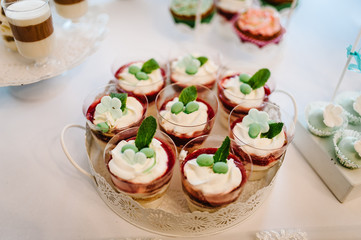 Dessert table for a party. cakes, pie, cupcakes. Colorful table with sweets and goodies for the wedding party reception, decorated dessert table. Delicious sweets on candy buffet.