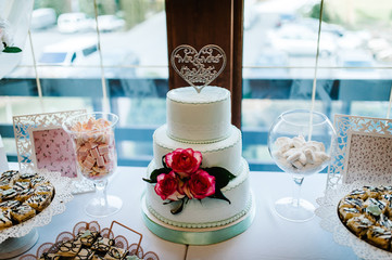 Dessert table for a party. cakes, pie, cupcakes. Colorful table with sweets and goodies for the wedding party reception, decorated dessert table. Delicious sweets on candy buffet.