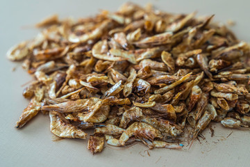 Pile of Dried Crayfish on brown background
