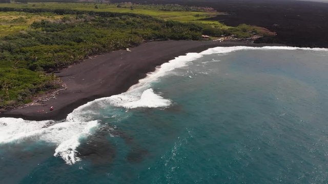 pohoiki bay aka Isaac hale park after recent lava flow, black sand from shattered hot lava has filled in the bay and created a beautiful beach.