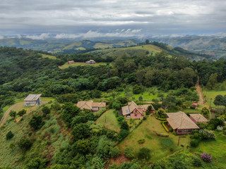 Fototapeta na wymiar Aerial view of luxury villa in tropical valley. Monte Alegre Do Sul. Brazil. Countryside destination for local tourist.
