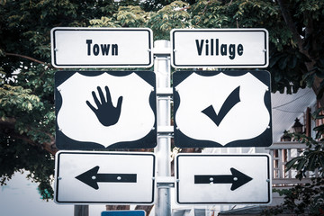 Street Sign to Village versus Town