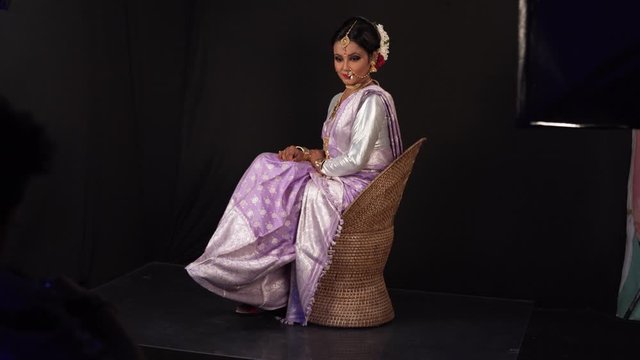 Beautiful Indian girl wearing bridal jewellery ornaments and smiling, studio shot