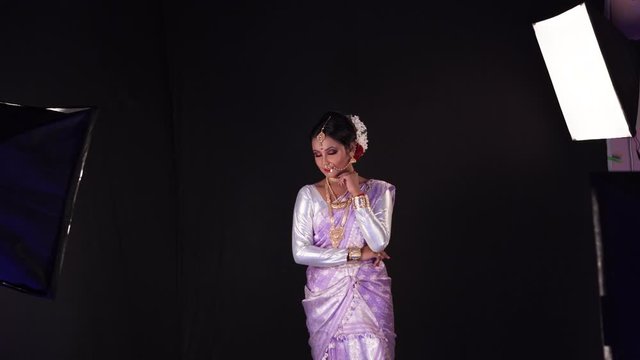 Beautiful girl in Indian style with light purple dress posing for studio photo shoot