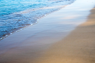 sandy beach and blue sea wave. Beautiful natural background. Tourism and travel.