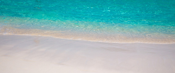sandy beach and blue sea wave. Beautiful natural background. Tourism and travel.