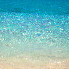 sandy beach and blue sea wave. Beautiful natural background. Tourism and travel.