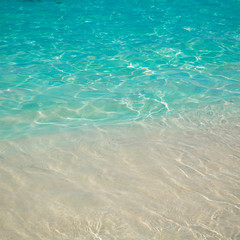 sandy beach and blue sea wave. Beautiful natural background. Tourism and travel.