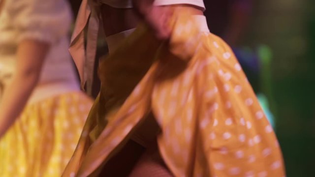 girls dancers dancing joyfully with yellow skirts at Cuba, exotic dancers close up