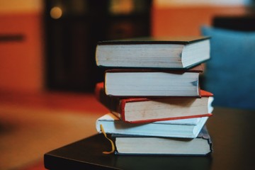 stack of books on wooden table