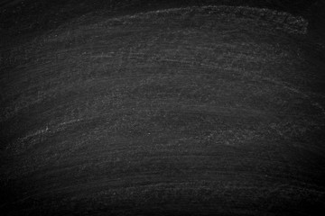 Naklejka premium Working place on empty rubbed out on blackboard chalkboard texture background with colorful crayons chalk for classroom or wallpaper, add text message.
