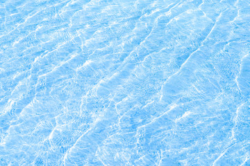 Obraz premium Modern swimming pool with blue color of water surface with sunlight reflection with summer vacation or holiday relax concept.