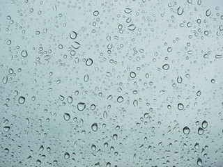 Rain droplets on a car's window on a rainy day - driver's perspective