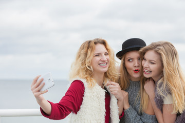 Three women taking selfie outdoor