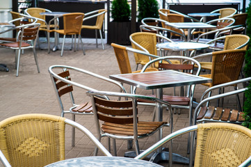 Empty chairs and tables have not yet opened a cafe. Background