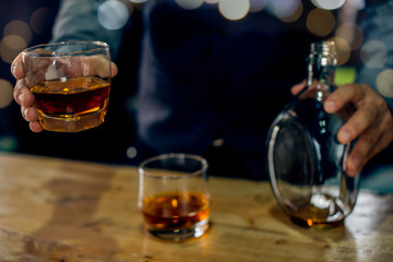 glass of brandy and cigar on table