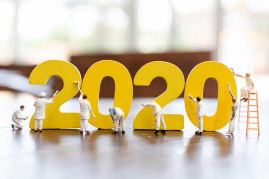 Miniature worker team painted number 2020  , Happy new year 2019 concept