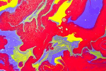 Fluid Art. Abstract wavy background or texture. Red, violet and yellow color mixing with golden spray