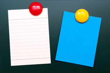 Empty colorful paper sheet with magnetic on rubbed out green board chalkboard texture background Copy space for add text or art work designs. © NaPUN