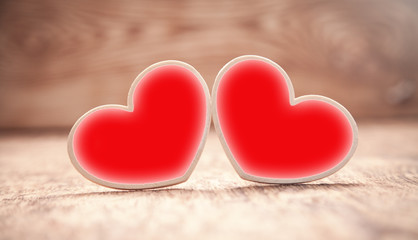 Fototapeta premium Wooden red hearts on wooden table.