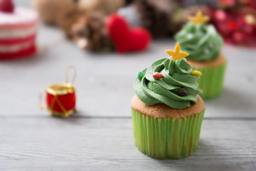 Green creamy topping with sugar bead on butter cup cake as for Christmas and Saint Patricks' Day and celebration