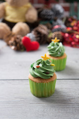 Green creamy topping with sugar bead on butter cup cake as for Christmas and Saint Patricks' Day and celebration
