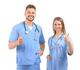 Male and female nurses showing thumb-up on white background