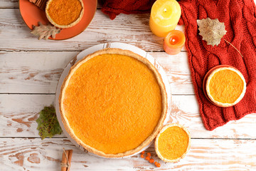 Tasty pumpkin pies on wooden background