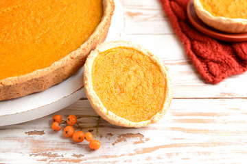 Tasty pumpkin pies on wooden background © Pixel-Shot