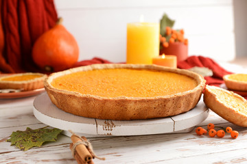Tasty pumpkin pie on wooden table