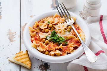 Traditional Italian dish, chowder, pottage, pasta e ceci served in old plate on old wooden...