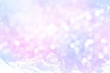 Winter shiny snowflakes blurred background in light blue pink colors. Blurry Christmas holiday background with snow flakes, soft glares of light
