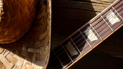 electric guitar and cowboy hat on the wooden boards 